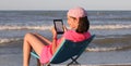 Little girl with pink bandana read an ebook Royalty Free Stock Photo