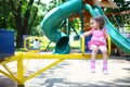 Little girl in a pink dress on the carousel spins