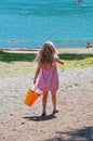 Little girl pink dress walking near beach Royalty Free Stock Photo