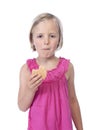 Little girl in pink eating a biscuit, isolated on white Royalty Free Stock Photo