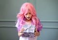 little girl with pink hair holding a gift box. Happy Vanilla Girl. Kawaii vibes. Candy colors design. Marry Royalty Free Stock Photo