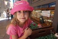 Little girl with pink hat in front of a grocery store, San Marino Royalty Free Stock Photo