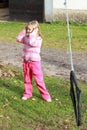 Little girl in pink holding ears