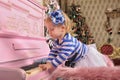 Little girl with a pink piano Royalty Free Stock Photo