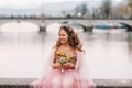 A little girl in a pink Princess dress with a bouquet in her hands walks through the old city of Zurich.Portrait of a girl in a Royalty Free Stock Photo