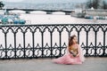 A little girl in a pink Princess dress with a bouquet in her hands walks through the old city of Zurich.Portrait of a girl in a Royalty Free Stock Photo