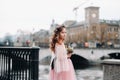 A little girl in a pink Princess dress with a bouquet in her hands walks through the old city of Zurich.Portrait of a girl in a Royalty Free Stock Photo