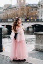 A little girl in a pink Princess dress with a bouquet in her hands walks through the old city of Zurich.Portrait of a girl in a Royalty Free Stock Photo