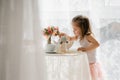 little girl in a pink skirt have breakfast, beautiful sunlight at home Royalty Free Stock Photo