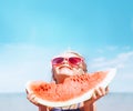 Little girl in pink sunglasses with big watermelon segment funny portrait. Healthy eating concept image Royalty Free Stock Photo
