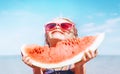 Little girl in pink sunglasses with big watermelon segment funny portrait. Healthy eating concept image Royalty Free Stock Photo