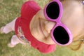 Little girl with pink sunglasses looking up Royalty Free Stock Photo