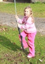 Little girl in pink on a swing Royalty Free Stock Photo