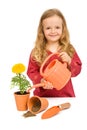Little girl planting flowers in pots