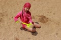 Little girl plauing on sea beach Royalty Free Stock Photo