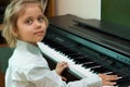 Little girl play on a electric piano