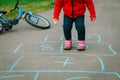 Little girl play hopscotch on playground