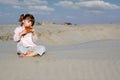 Little girl play panpipe in desert Royalty Free Stock Photo