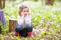 Little girl  play with real rabbit in the garden. Cute child at Easter egg hunt with  pet bunny. Spring outdoor fun for kids with Royalty Free Stock Photo