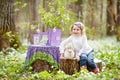 Little girl  play with real rabbit in the garden. Laughing child at Easter egg hunt with  pet bunny. Spring outdoor fun for kids Royalty Free Stock Photo