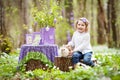 Little girl  play with real rabbit in the garden. Laughing child at Easter egg hunt with  pet bunny. Spring outdoor fun for kids Royalty Free Stock Photo