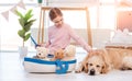 Little girl play with sea ship with golden retriever dog Royalty Free Stock Photo