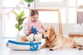 Little girl play with sea ship with golden retriever dog Royalty Free Stock Photo