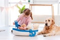 Little girl play with sea ship with golden retriever dog Royalty Free Stock Photo