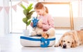 Little girl play with sea ship with golden retriever dog Royalty Free Stock Photo