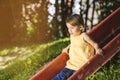 Little girl on the playground atop a slide
