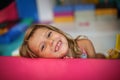 Little girl in playground. Caucasian girl looking at camera.