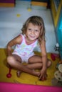 Little girl in playground. Caucasian girl playing with toy. Look Royalty Free Stock Photo