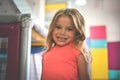 Little girl in playground. Caucasian girl looking at camera.