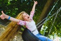 Little girl at playground. Child playing outdoors in summer. Teenager on a swing. Royalty Free Stock Photo