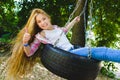 Little girl at playground. Child playing outdoors in summer. Teenager on a swing. Royalty Free Stock Photo