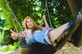 Little girl at playground. Child playing outdoors in summer. Teenager on a swing. Royalty Free Stock Photo