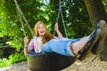 Little girl at playground. Child playing outdoors in summer. Teenager on a swing. Royalty Free Stock Photo