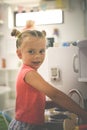 Little girl in playground. Girl playing in children kitchen.