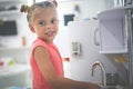 Little girl in playground. Girl playing in children kitchen.