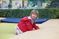 Little girl on playground in a park, jumping on trampoline. Little Girl seating on a Trampoline Royalty Free Stock Photo