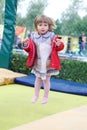 Little girl on playground in a park, jumping on trampoline Little Girl on a Trampoline Royalty Free Stock Photo