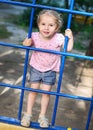 Little girl on the playground rises