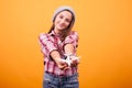 Little girl playin with toy plane in studio on yellow background Royalty Free Stock Photo