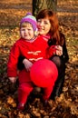 Little girl playing in autumn