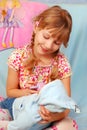 Little girl playing with baby doll Royalty Free Stock Photo
