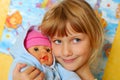 Little girl playing with baby doll Royalty Free Stock Photo