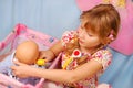 Little girl playing with baby doll Royalty Free Stock Photo