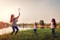 Little girl playing badminton with sister in summer park. Kids having fun outdoors. Close up of shuttlecock Royalty Free Stock Photo