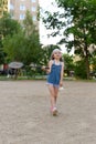 A little girl playing badminton in a yard of an apartment buiding Royalty Free Stock Photo