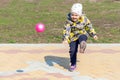 Little girl playing ball on the street Royalty Free Stock Photo